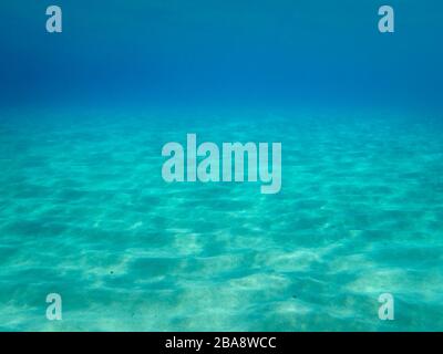 Sandy underwater sand on a shallow seabed in the Mediterranean sea with reflections of sunlight, natural scene, Sardinia, Italy Stock Photo