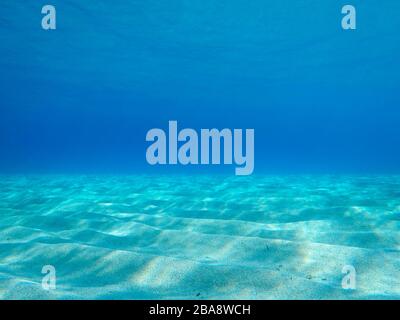 Sandy underwater sand on a shallow seabed in the Mediterranean sea with reflections of sunlight, natural scene, Sardinia, Italy Stock Photo
