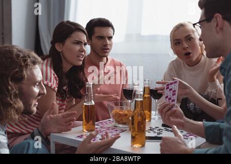 KYIV, UKRAINE - JANUARY 27, 2020: displeased friends quarreling while playing lotto game Stock Photo