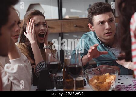 KYIV, UKRAINE - JANUARY 27, 2020: angry friends quarreling while playing lotto game Stock Photo