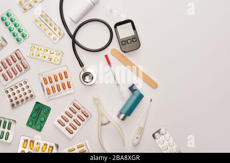 Top view of colorful pills, syringe, ampule and medical objects on white Stock Photo