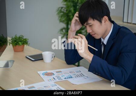 Asian business man having problems in the office. Stock Photo