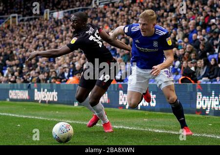 Reading's Yakou Meite battle for the ball with Birmingham City's Kristian Pedersen Stock Photo