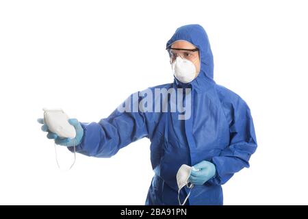 Man in protective clothing give face masks to someone. Coronavirus concept. Stock Photo