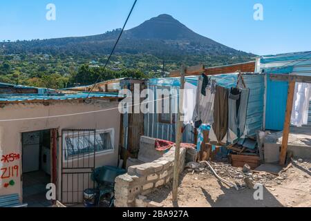 Small dwelling with washing hanging outside in the overcrowded Imizamo Yethu Township, Hout Bay, Cape Town, South Africa Stock Photo