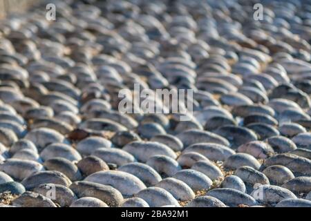Isolated close up of a stone sidewalk made of natural river stones- Rhodes Greece Stock Photo