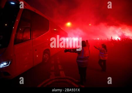 The Liverpool bus arrives ahead of the match as fans let off flares Stock Photo