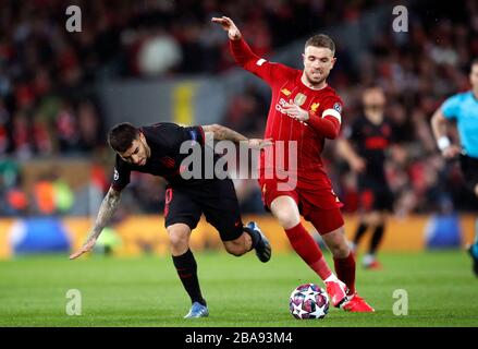 Atletico Madrid's Angel Correa (left) and Liverpool's Jordan Henderson battle for the ball Stock Photo