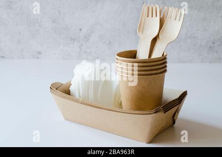 Eco-friendly biodegradable cardboard or paper dishes. Zero waste recycling concept. Catering and street fast food paper cups, plates and wooden forks. Stock Photo