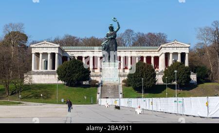 Panorama of Bavaria Statue & Ruhmeshalle (hall of fame) at Theresienwiese. The white fence belongs to a Coronavirus drive in testing station. Stock Photo