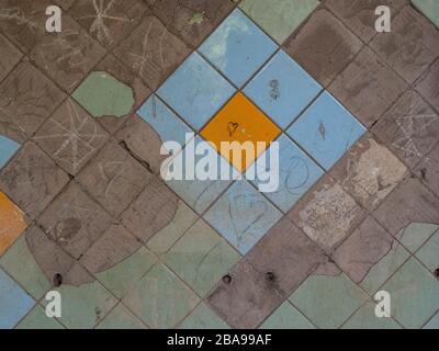 Old tiles and textures on decaying house wall Stock Photo