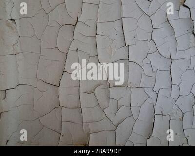 Cracking and peeling paint on a wall Stock Photo