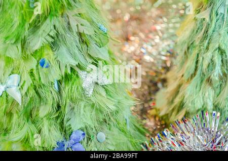 olorful christmas trees made of feathers. Christmas festive toy. Stock Photo