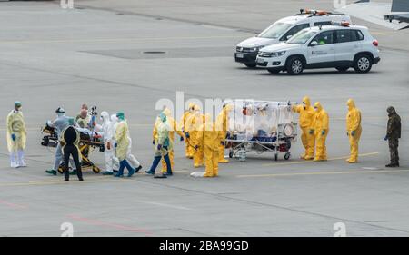 Dresden, Germany. 26th Mar, 2020. A seriously ill Covid 19 patient is transferred from an Italian military aircraft to a patient transport ambulance at Dresden International Airport. Credit: Robert Michael/dpa-Zentralbild/dpa/Alamy Live News Stock Photo
