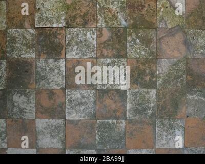 Old tiles and textures on decaying house wall Stock Photo