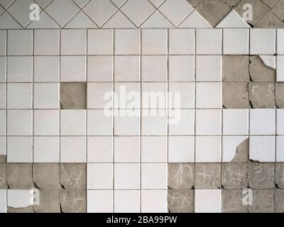 Old tiles and textures on decaying house wall Stock Photo