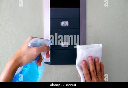 Closeup man's hands cleaning the elevator panel Stock Photo