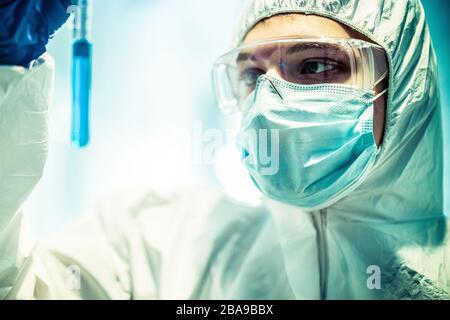 corona virus concept. male doctor reviewing test-tube Stock Photo