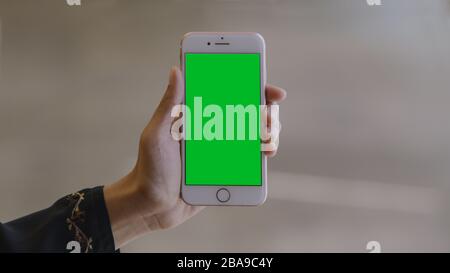 Woman using a smartphone (green screen) Stock Photo