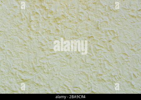 Close up of cream coloured painted rough cast wall render background Stock Photo