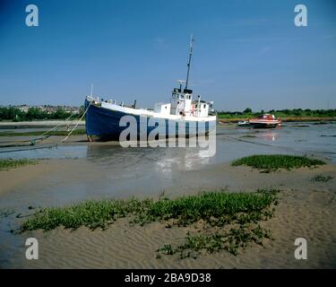 Boat at low tide, Barry Island, Vale of Glamorgan, South Wales. Stock Photo