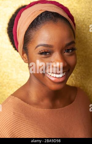 Portrait of a young black woman wearing a headband and looking at camera. Stock Photo