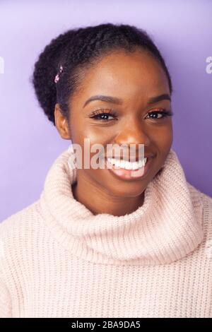 Portrait of a beautiful young woman smiling and  wearing a woollen jumper Stock Photo