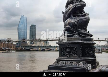 Ornate cast iron fish design lamp post with One Blackfriars (The Boomerang) building and Southbank Tower building in the background, London, UK Stock Photo