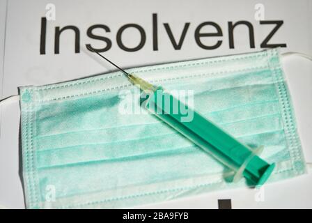 Covid-19 symbol in  Marktoberdorf, Germany, March 26, 2020. Injection needle for vaccination and a mouth protection. Due to the Corona virus disease (COVID-19) there is a big bankruptcy risk for companies  on March 26, 2020 in Marktoberdorf, Germany  © Peter Schatz / Alamy Live News Stock Photo