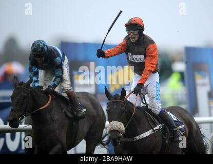 Jockey Sam Waley-Cohen celebrates after he wins the William Hill King George VI Chase with Long Run ahead of Captain Chris ridden by jockey Richard Johnson Stock Photo