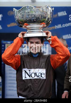 Jockey Sam Waley-Cohen celebrates after he wins the William Hill King George VI Chase with Long Run Stock Photo