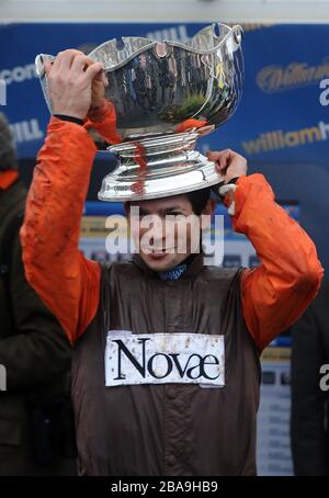 Jockey Sam Waley-Cohen celebrates after he wins the William Hill King George VI Chase with Long Run Stock Photo