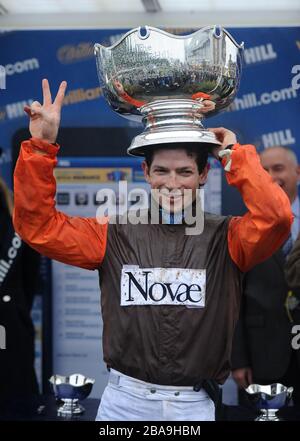 Jockey Sam Waley-Cohen celebrates after he wins the William Hill King George VI Chase with Long Run Stock Photo