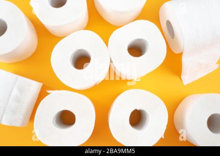 top view of toilet paper rolls on orange background Stock Photo