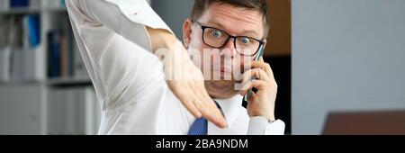 Male executive talking cellphone about bad consequences Stock Photo