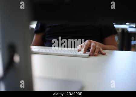 Close up of male hands typing with keyboard Stock Photo