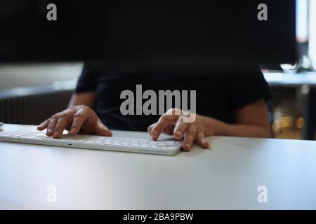 Close up of male hands typing with keyboard Stock Photo