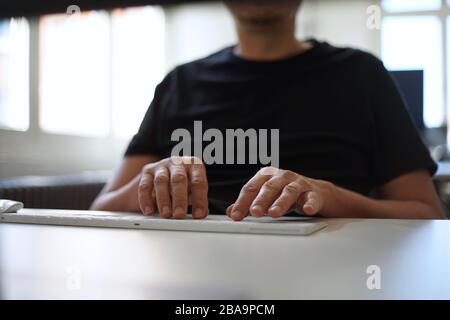 Close up of male hands typing with keyboard Stock Photo