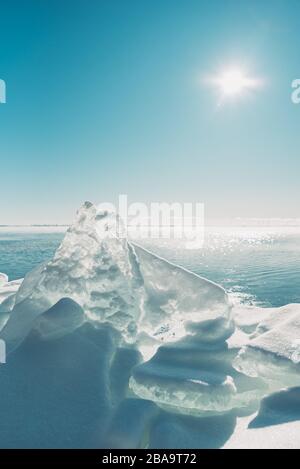 Close up of large piece of ice along the shoreline of lake in Canada. Stock Photo