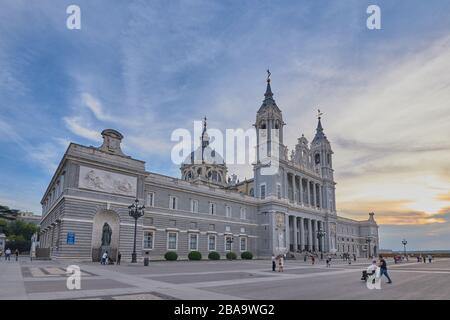 Catedral de la Almudena,Madrid,Spain;September 16 2018:Image of Almudena cathedral with people walking and statues of ornaments with bells on top and Stock Photo