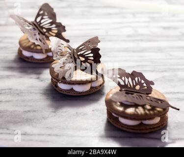 Giant Tiramisu Macarons with Chocolate Butterflies Stock Photo