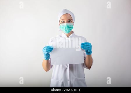 Clipboard with blanc sheet in hands of female doctor Stock Photo