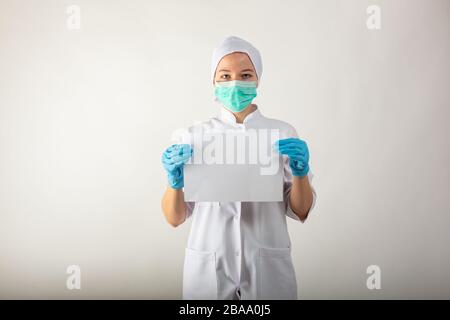 Clipboard with blanc sheet in hands of female doctor Stock Photo