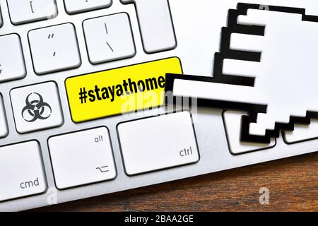 PHOTOMONTAGE, computer key with the Hashtag #stayathome and biology danger sign, FOTOMONTAGE, Computertaste mit dem Hashtag #stayathome und Biogefährd Stock Photo