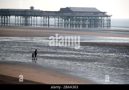 People on Blackpool beach, after the Prime Minister placed the country in lockdown earlier in the week to curb the spread of coronavirus. Stock Photo
