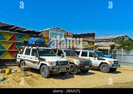 Off-road vehicles waiting at the Letish Restaurant for the onward journey to the Dallol geothermal area, Berhale, Afar Region, Ethiopia Stock Photo
