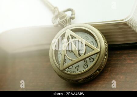old antique classic clocks with a book on table  Stock Photo