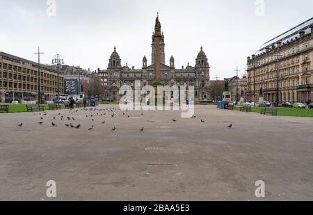 Glasgow, Scotland, UK. 26 March, 2020. Views from city centre in Glasgow on Thursday during the third day of the Government sanctioned Covid-19 lockdown. The city is largely deserted. Only food and convenience stores open. Pictured; George Square is virtually deserted. Iain Masterton/Alamy Live News Stock Photo