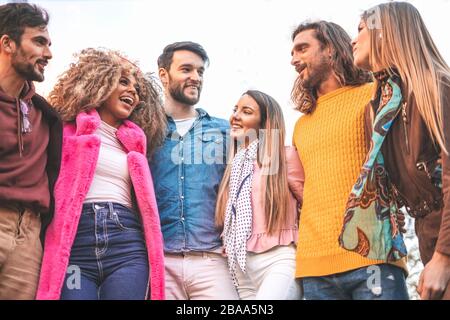 Happy diverse friends standing, embracing, joyful multiracial students or colleagues group in good friendly relations having fun, young people enjoyin Stock Photo