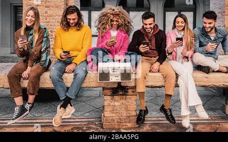 Young people having fun using their smartphones. Stock Photo